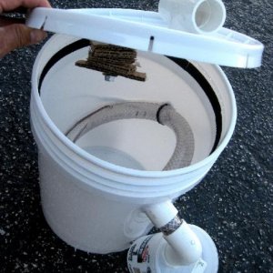 Simple five gallon bucket version, cardboard pieces slid onto a bolt in the lid is where adult flies lay their eggs. Just add a crawl off tube into a